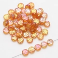 Macro detail of amber 10mm glass rose beads with iridescent finish for DIY jewelry - Gold Rose Red
