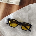 Close-up of cat-eye kids sunglasses featuring a black resin frame and yellow tinted lenses - Black and Yellow