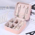 Pink portable jewelry storage box with ring slots and necklace hooks in a textured finish - Lotus Pink