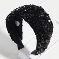 Close-up of black sequin headband with soft velvet base on a professional stand - Solid Black Sequin