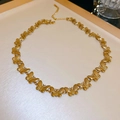 Close-up of gold butterfly necklace showing matte metal finish and lobster clasp - Gold Butterfly Necklace