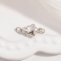 Primer plano de cierre estrella de plata S925 pulida para la creación de joyas DIY - Cierre de Estrella Pequeño / Oro Blanco