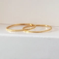 Detail of ultra-slim gold plated rings featuring a frosted sand finish on a white background - US 5 / Gold