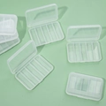 Transparent 6-compartment plastic jewelry storage box shown in a group of six pieces - 8*5.5*1.6cm (6 Grids)