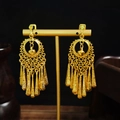 Detail of bohemian gold drop tassel earrings with hollow rings on a black display - Gold Spiral Hollow Circle