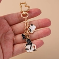 Creative heart cat keychain with gold feline clip and enamel animal charms for bags - Black and White Cat
