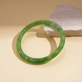 Detail of a green resin bangle with stone texture leaning on a natural rock - Green-Small