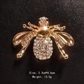 Golden honey bee brooch pin with sparkling crystal wings on black leather background - Gold Wing Rhinestone Bee