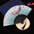 Classic Chinese folding fan with red plum blossoms and black tassel on dark base - No. 42