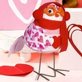 Detailed close-up of a plush Valentine bird doll with heart patterns and red scarf - Wearing Scarf Bird