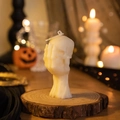Skull with skeletal hand scented candle in creamy white for Halloween decor - Hand-holding Skull / White