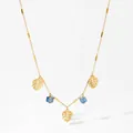 Golden necklace featuring hollow monstera leaf charms and light blue cubic crystals - Gold