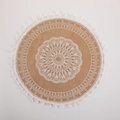 Round light brown jute placemat featuring white lace patterns and small fringe tassels - White Pom-poms Pattern 5