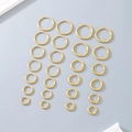 Flat lay of multiple gold polished hoop earrings in various sizes on grey surface - 2mm Thickness-16mm Inner Diameter / Gold