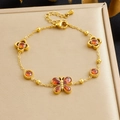 Bracciale in acciaio dorato con farfalla, fiori e cristalli di zircone a cuore rosso - Zircone Rosso (B2017)