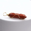 Handmade red stone hexagonal pendant with golden wire wrap on a white background - Red Jasper