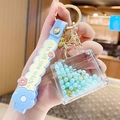 Blue silicone wristlet keychain with handbag-shaped charm and golden floating beads - Pearl Handbag - Blue