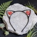 Close-up of cat ear headband with red crystals and beads on a natural rock background - Red Crackle Cat Ears