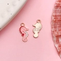 Pink seahorse charms for DIY jewelry making with gold enamel finish on soft background - Pink Enamel Ocean Seahorse