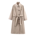 Detailed view of oatmeal-colored wool coat featuring a belted waist and dark buttons - XS / Apricot