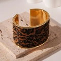 Detail of a leopard print cuff bracelet on elegant beige travertine stone pedestals - 7# Dark Coffee Leopard Flocking Open Cuff Bracelet