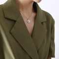 Silver geometric star and moon medallion necklace on model in deep green blazer - Silver (P302-Steel Color Necklace)