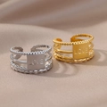 Detailed close-up of adjustable three-layer rings with engraved LOVE plate in gold and silver - LOVE Engraved Multilayer