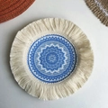 Handwoven round blue and white geometric coaster with beige tassels on white table - 17cm Sea Blue Floral Coaster Style 6-1