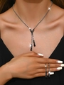 Macro shot of silver bridal necklace and earrings with black rhinestones in tassel style - 603 Black Necklace + Stud Earrings Set