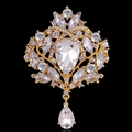 Close-up of vintage gold alloy brooch with crystal rhinestones and pear-shaped drop - 18k Gold Plated White