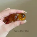 Macro shot of amber resin ball earrings with insect specimen detail and polished finish - Patchwork Resin Beads (116#) / Dark Brown Gold