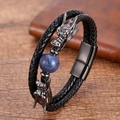 Detail of dragon head charms on black braided leather bracelet with blue stone bead - Dragon Head Lapis