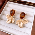 Detailed shot of vintage goldfish earrings with brown gemstones in a wooden jewelry box - Gold-Coffee (Silver Pin)