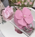 Detailed top view of pink leather petal tote bag with satin drawstring pouch and floral decor - Pink