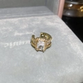 Detailed macro view of a gold-tone ear cuff set with a large emerald-cut clear zircon stone - Baguette Main Stone With Surrounding Zircon (5#) / Gold