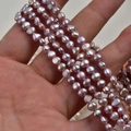 Macro shot of 4-5mm lavender baroque freshwater pearls strands for DIY jewelry - Natural Purple - Standard Grade