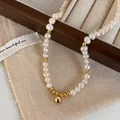 Detailed close-up of natural freshwater pearl necklace with polished gold bead pendant - Freshwater Pearl Gold Ball Pendant Necklace