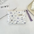 Detailed close-up of quilted floral cosmetic bag with purple bear and star patterns - Star Bear