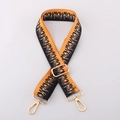 Detail of adjustable 38mm wide bag strap featuring orange and black flame pattern - Orange Black Flame / Light gold