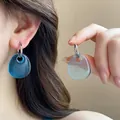 Close-up of blue teardrop pendant earrings with silver hooks worn by a model - Silver-Blue (31# Ear Buckle)