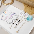 Golden necklaces with clover and pearl pendants on luxury jewelry display cards - Random Mixed Patterns