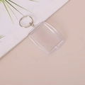 Clear acrylic rectangular photo keychain with a silver metal ring on a beige surface - Rectangle 4.3x6cm