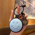 Light blue faux leather round smiley keychain charm with black leather strap and gold lettering - Leather-Blue Smile