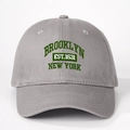 Detailed close-up of dark green Brooklyn New York embroidery on a grey cotton baseball cap - One Size / Gray