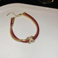 Close-up of dual-layer red leather braided rope bracelet with a gold zircon X pendant - Wine Red X Cross Double Layer Bracelet