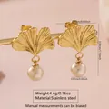 Golden stainless steel ginkgo leaf earrings with dangling white imitation pearl accents - Ginkgo Leaf Pearl Drop (FYD6052EH)