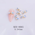 Detailed close-up of aurora heart bow nail charms MZH-8065 with metal base on nail - White Moonlight Gold Base Bow (8065)