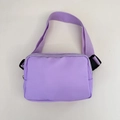Detail view of purple nylon waist bag with adjustable strap and black plastic buckle clip - 21*15*6cm / Violet