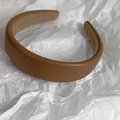 Detail view of brown faux leather headband with lychee texture and non-slip lining - Khaki