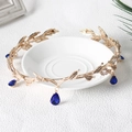 Detail of bridal gold leaf crown with sparkling clear crystals and blue teardrop pendant - Gold with Blue Stone